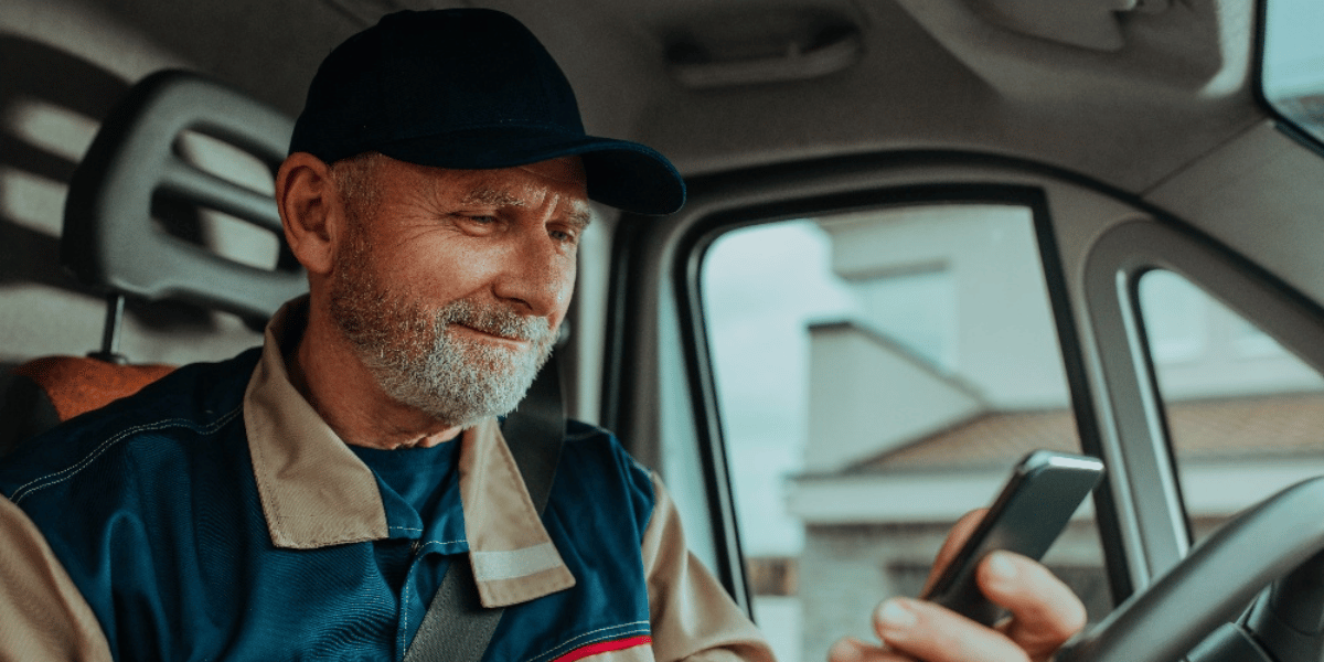 Man looking at phone in car